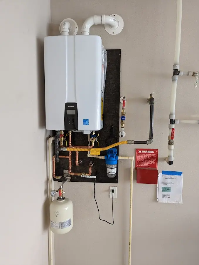 Professional plumber installing copper piping in a Rockport home